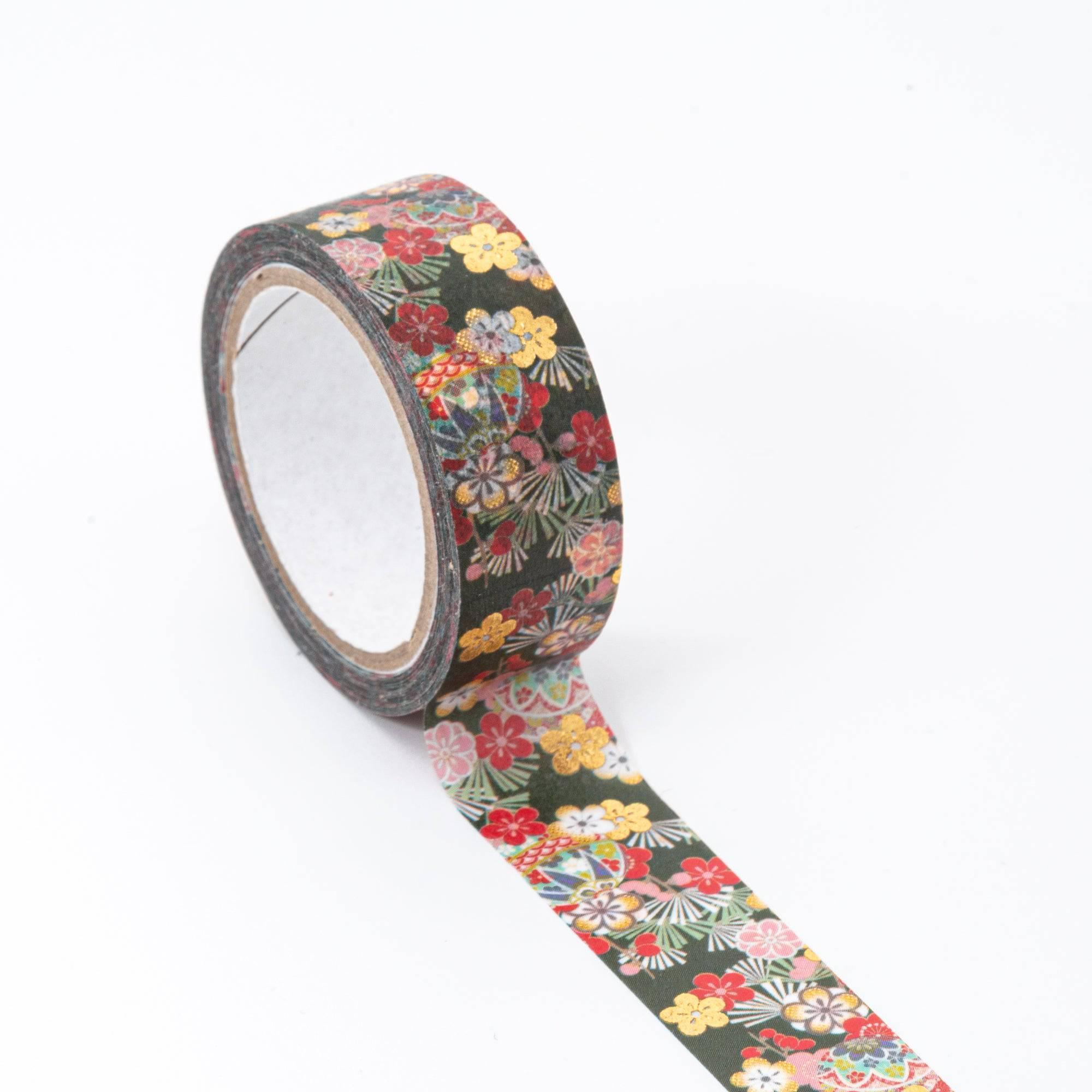 Roll of Iyo Washi Tape with temari plum designs, unraveling to reveal its artistic motifs, placed on a wooden surface under soft lighting.  