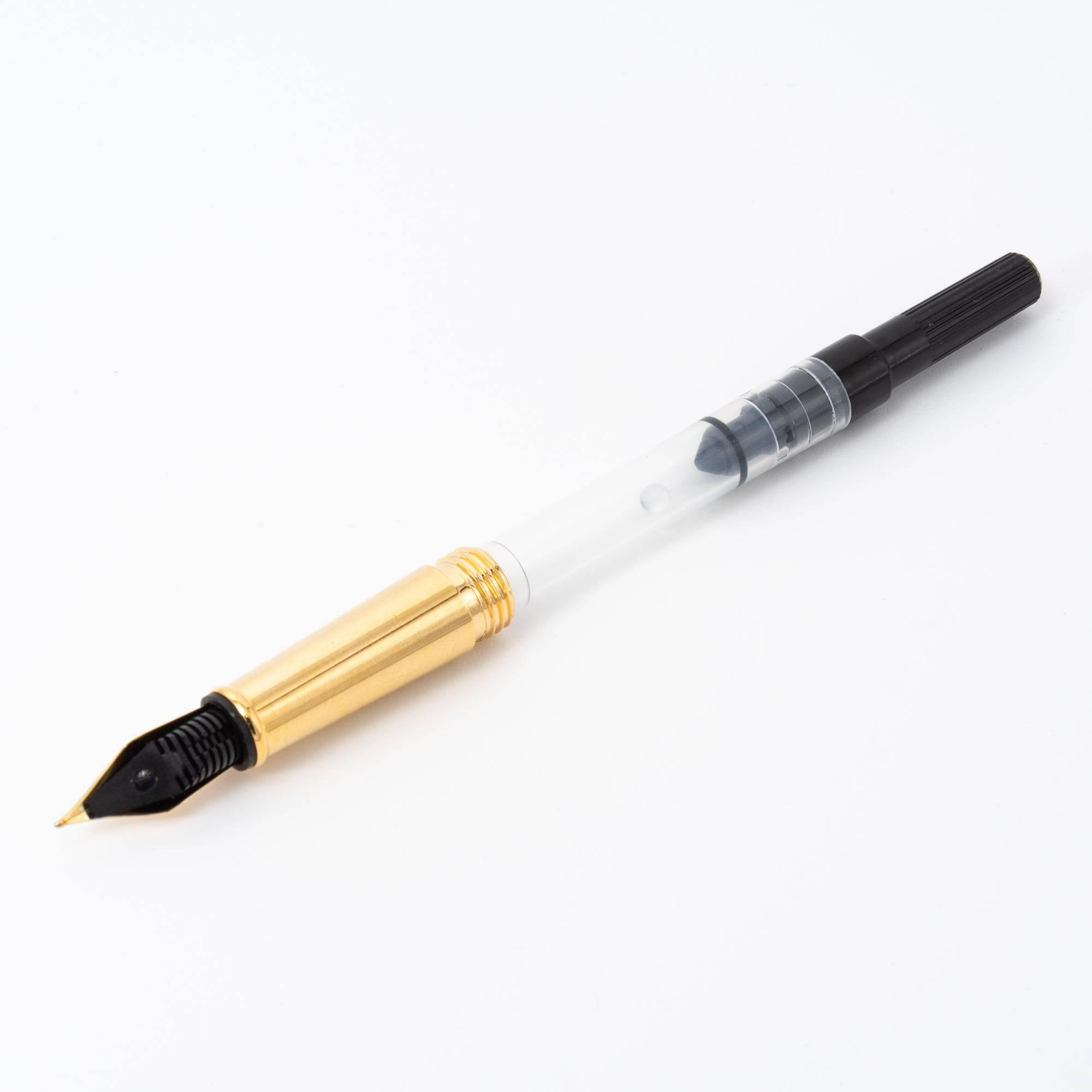 A Japanese fountain pen converter with a gold grip and transparent ink reservoir, offering a convenient and eco-friendly ink refilling option.  