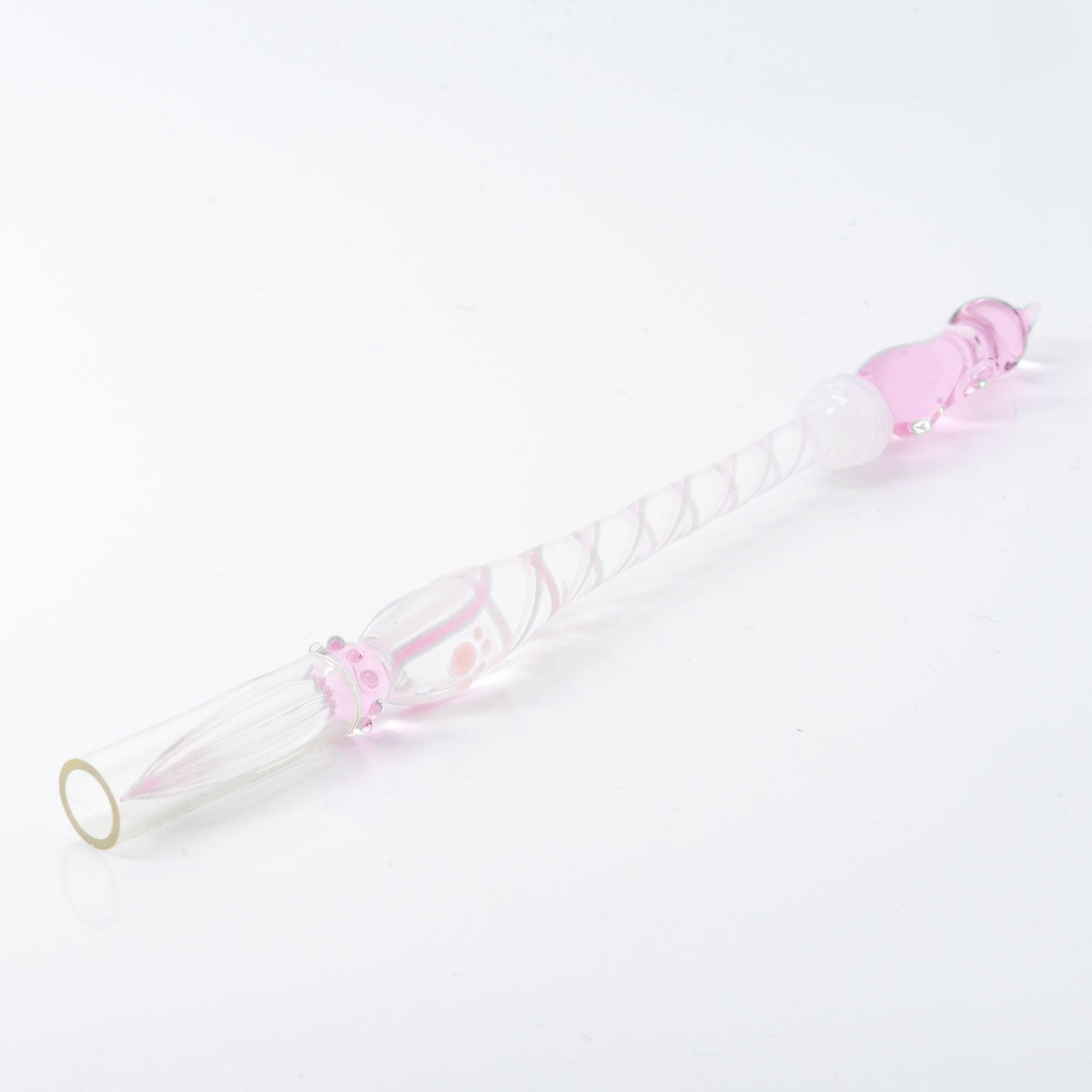 A delicate pink glass dip pen featuring a cat design at the top and a twisted, clear handle, creating a whimsical and elegant look.