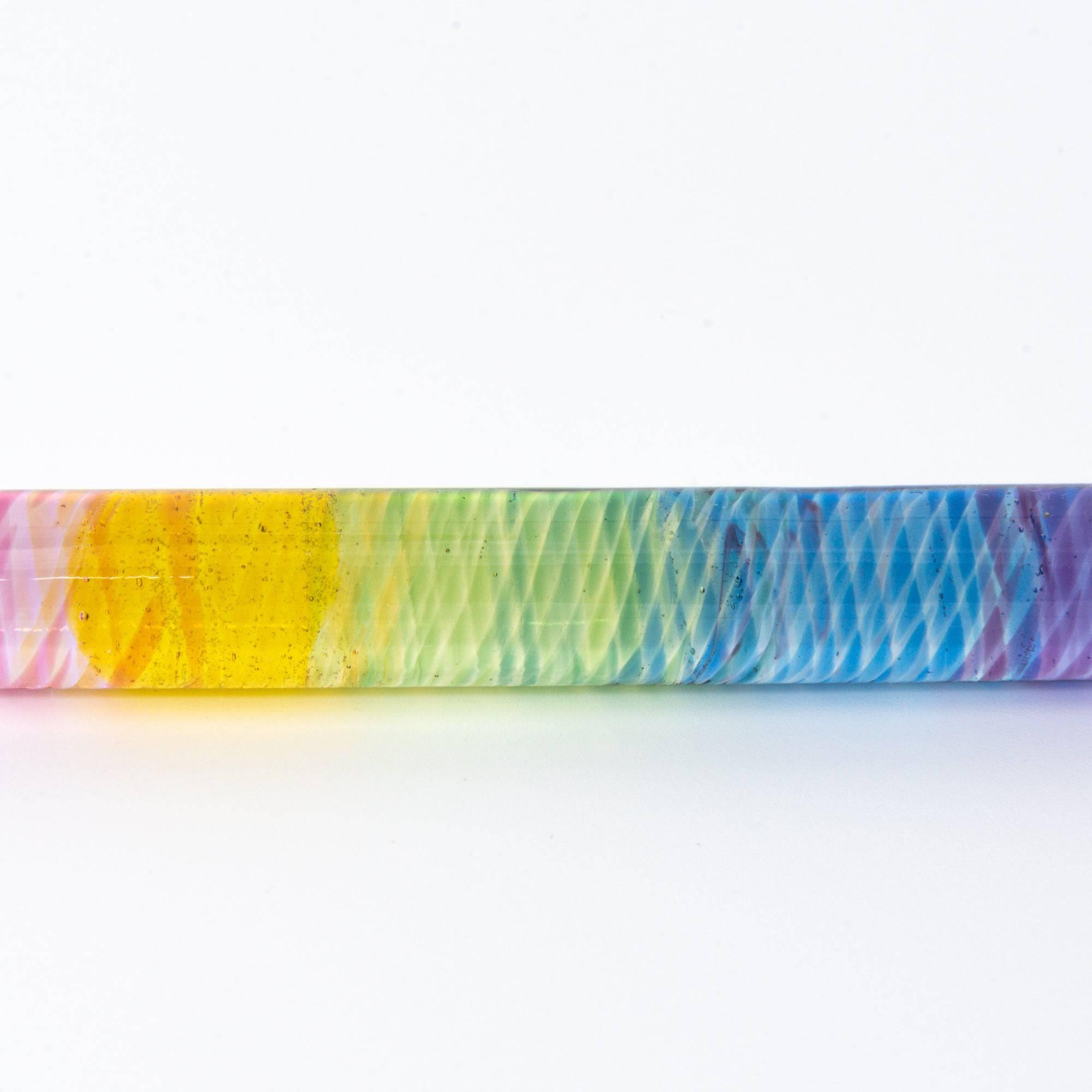 Short glass dip pen with vibrant rainbow colors and a spiral design, perfect for Japanese stationery enthusiasts, displayed on a clean white background.