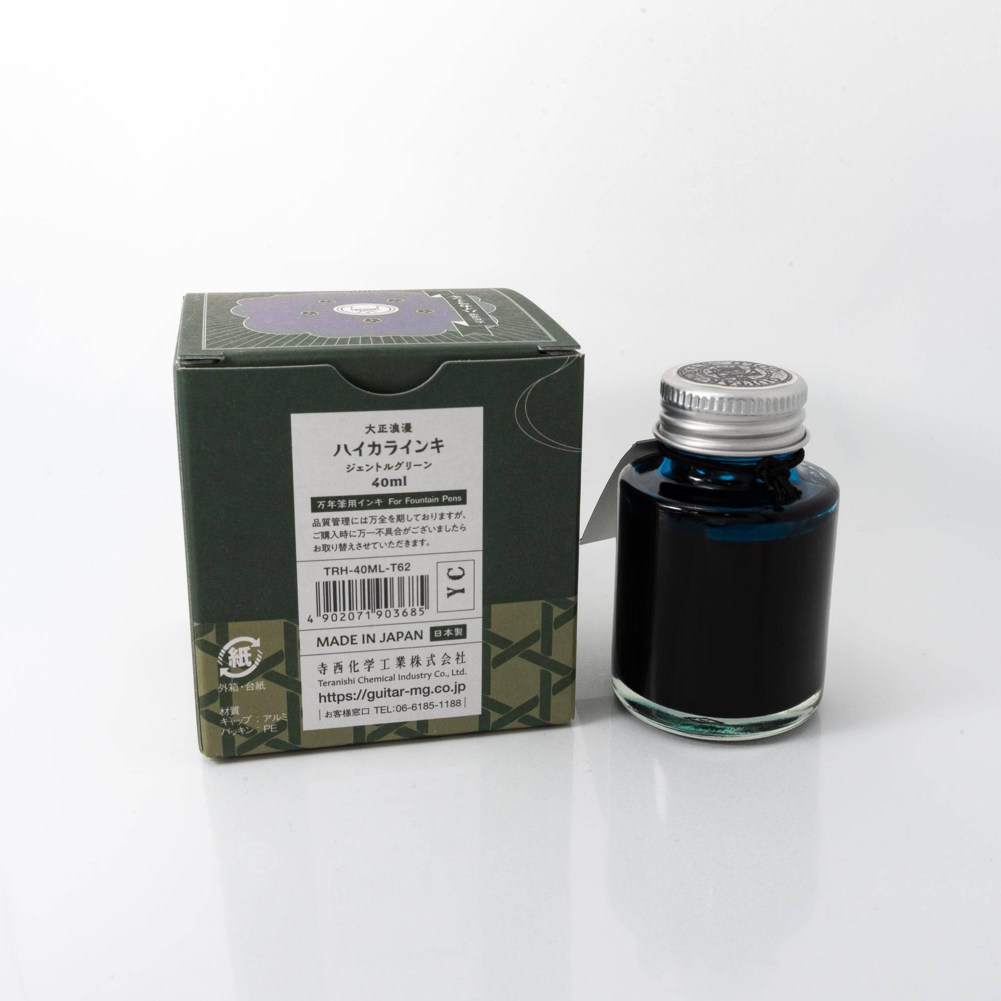 Top view of the Taisho Romance Gentle Green ink bottle, highlighting its soft green ink, surrounded by warm wooden tones.  