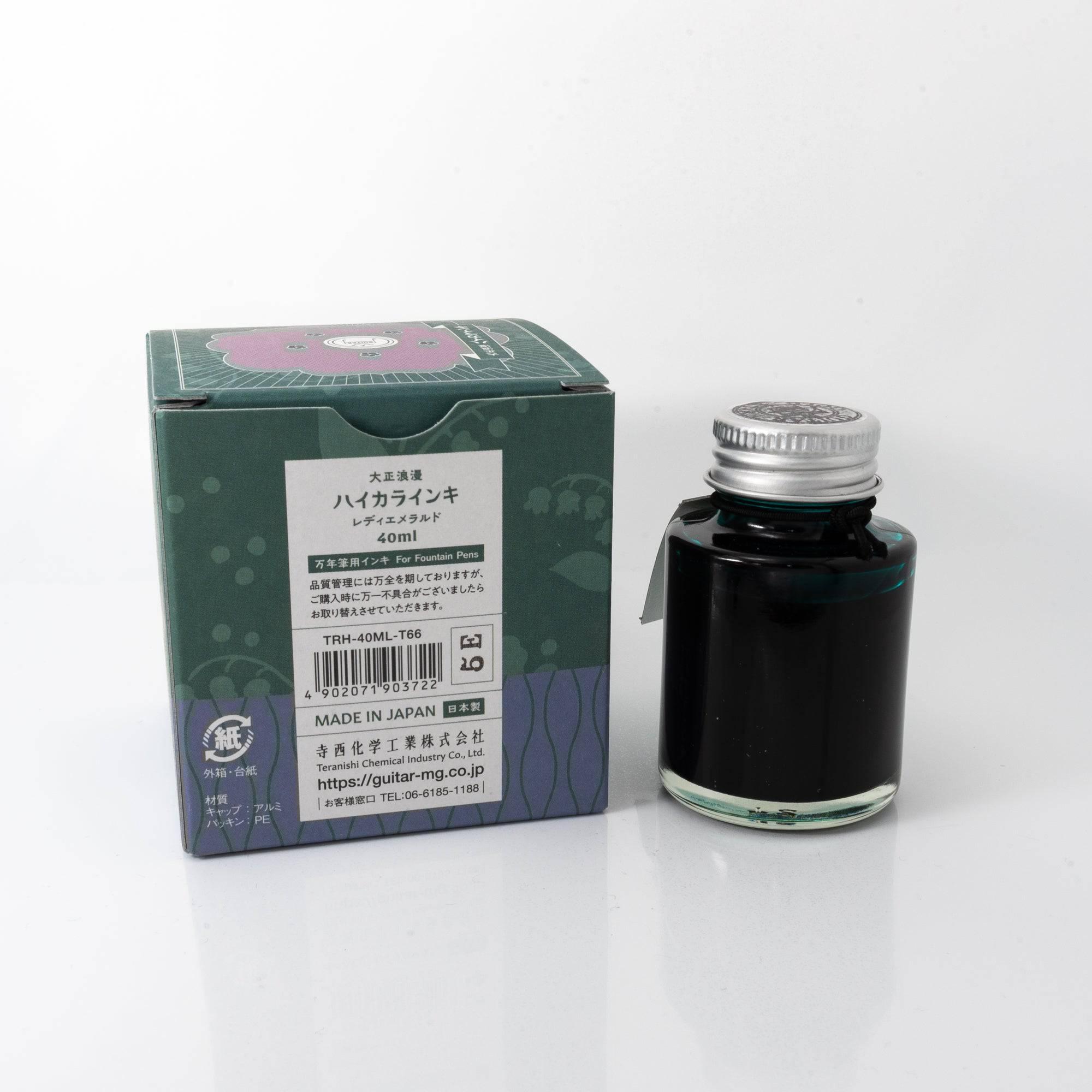 Top view of the Taisho Romance Lady Emerald ink bottle, highlighting its striking green ink, surrounded by natural wooden tones.  