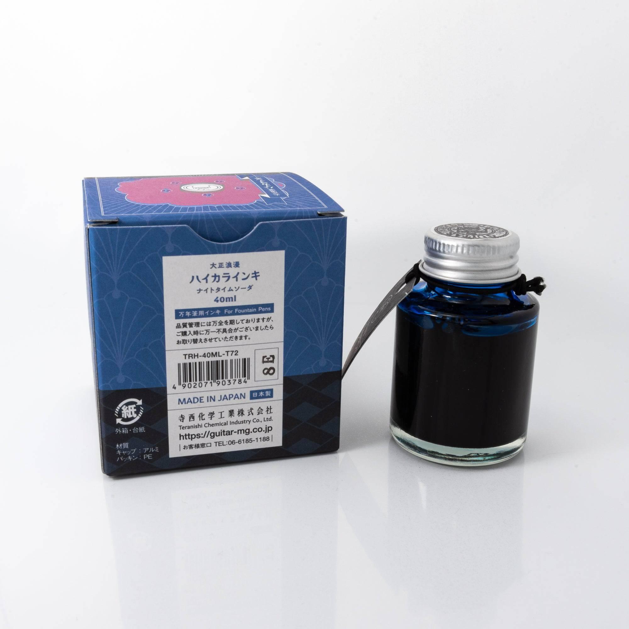 Top view of the Taisho Romance Nighttime Soda ink bottle, highlighting its rich blue ink, surrounded by natural wooden tones.  