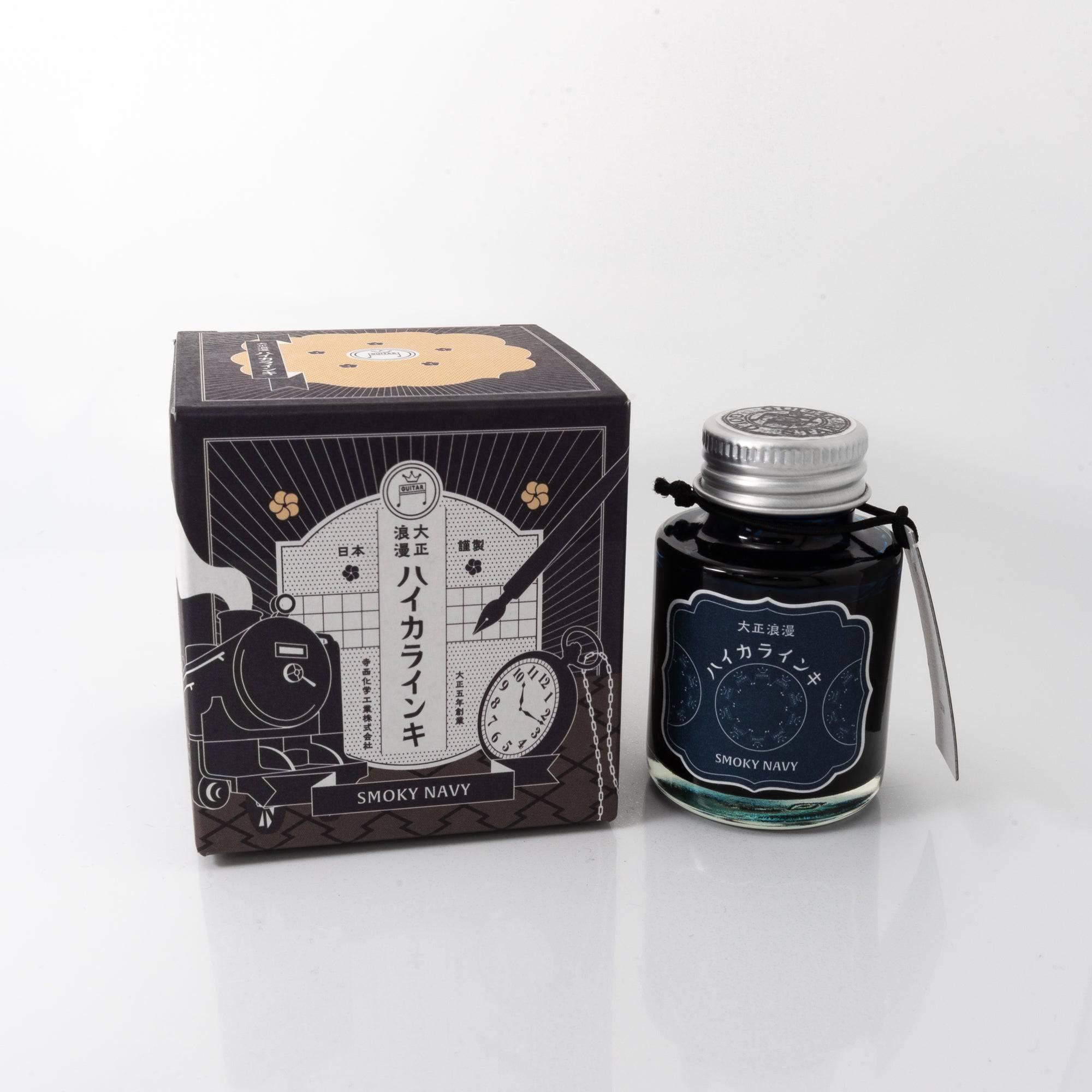 Taisho Romance Smoky Navy fountain pen ink bottle with a deep navy hue, placed on a wooden desk under soft natural light.  