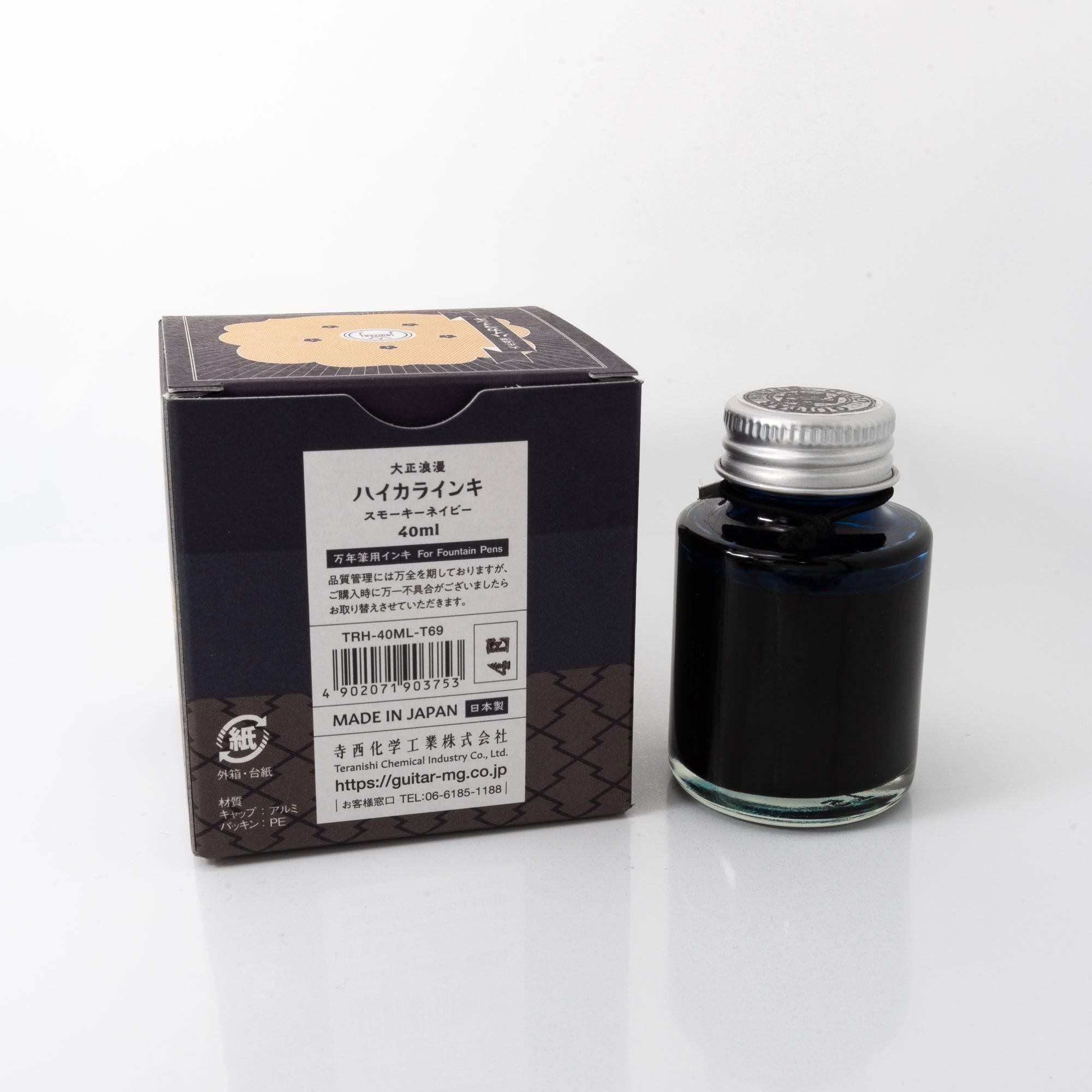 Top view of the Taisho Romance Smoky Navy ink bottle, highlighting its deep navy ink, surrounded by natural wooden tones.  