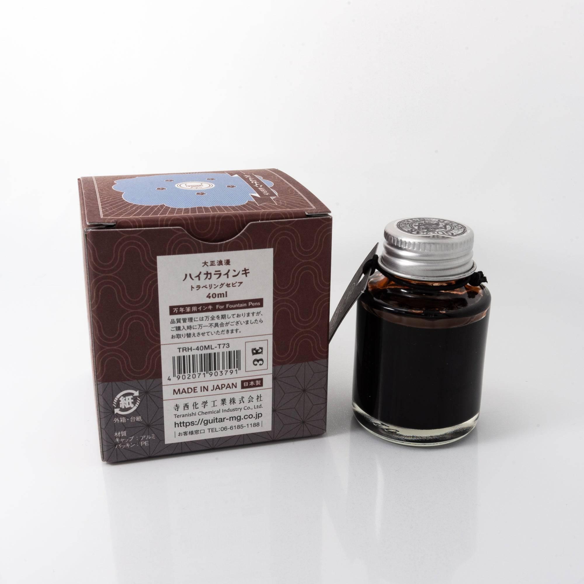 Top view of the Taisho Romance Traveling Sepia ink bottle, highlighting its warm sepia ink, surrounded by natural wooden tones.  