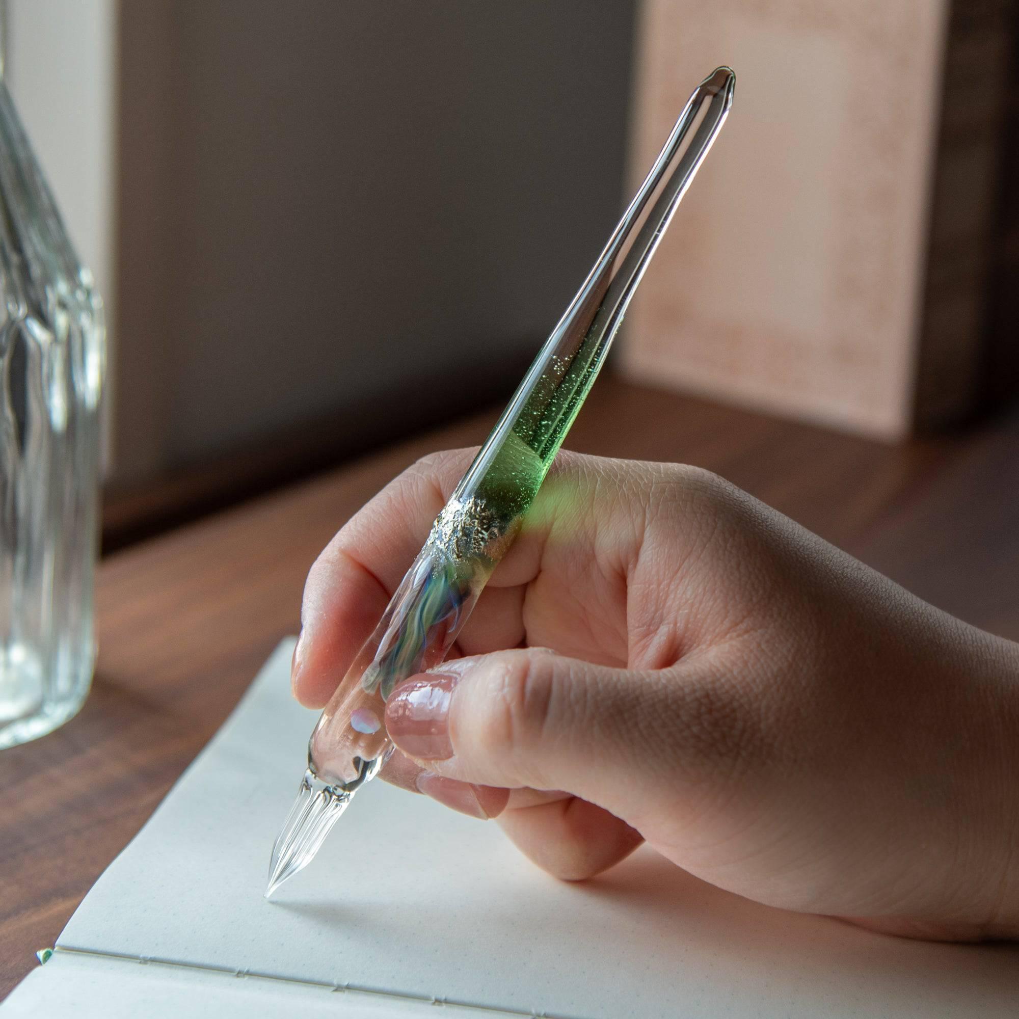 Glass pen with a light blue gradient and suspended opal, accented with silver. A luxurious writing instrument for those who appreciate elegance.