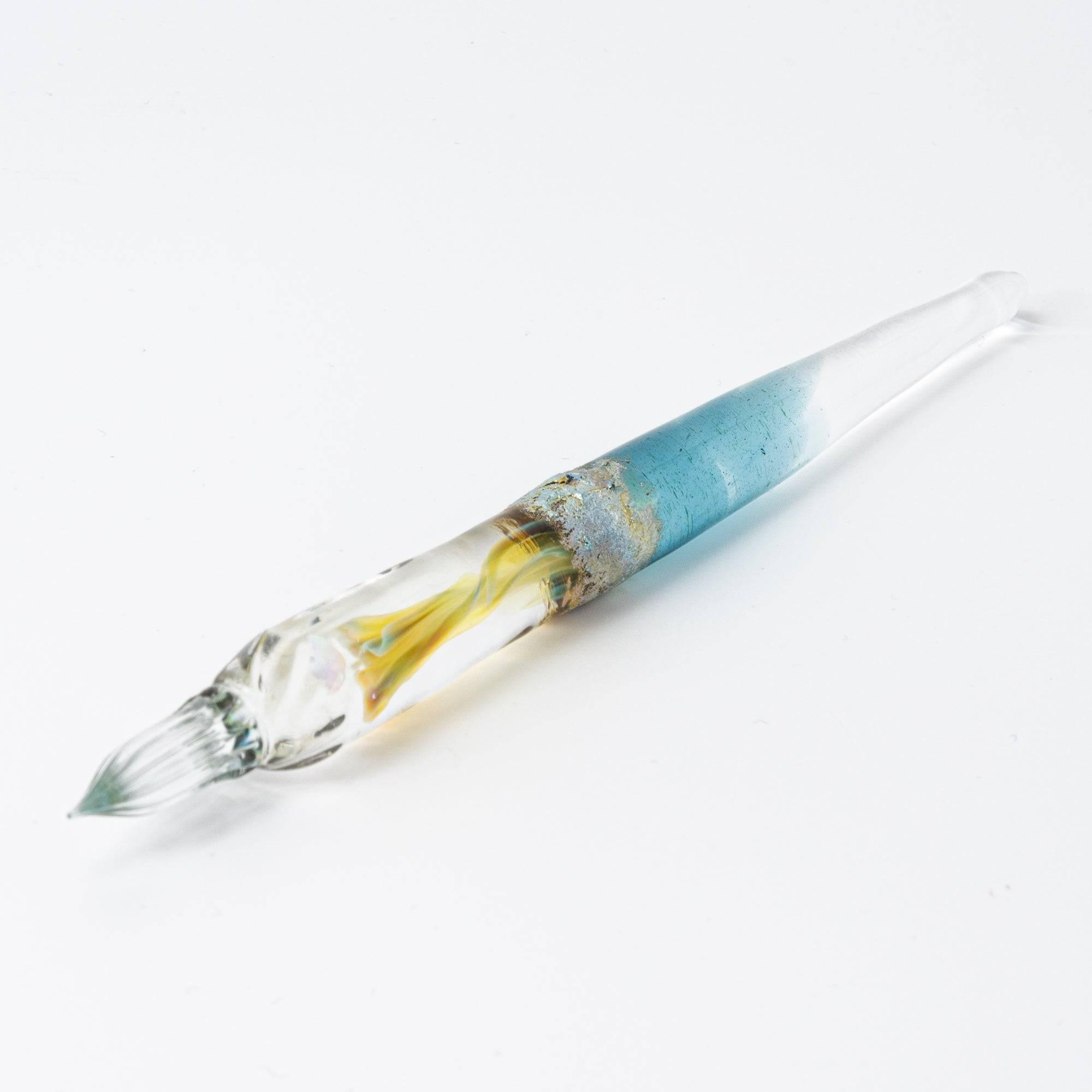 Glass pen with a light blue gradient and suspended opal, accented with silver. A luxurious writing instrument for those who appreciate elegance.