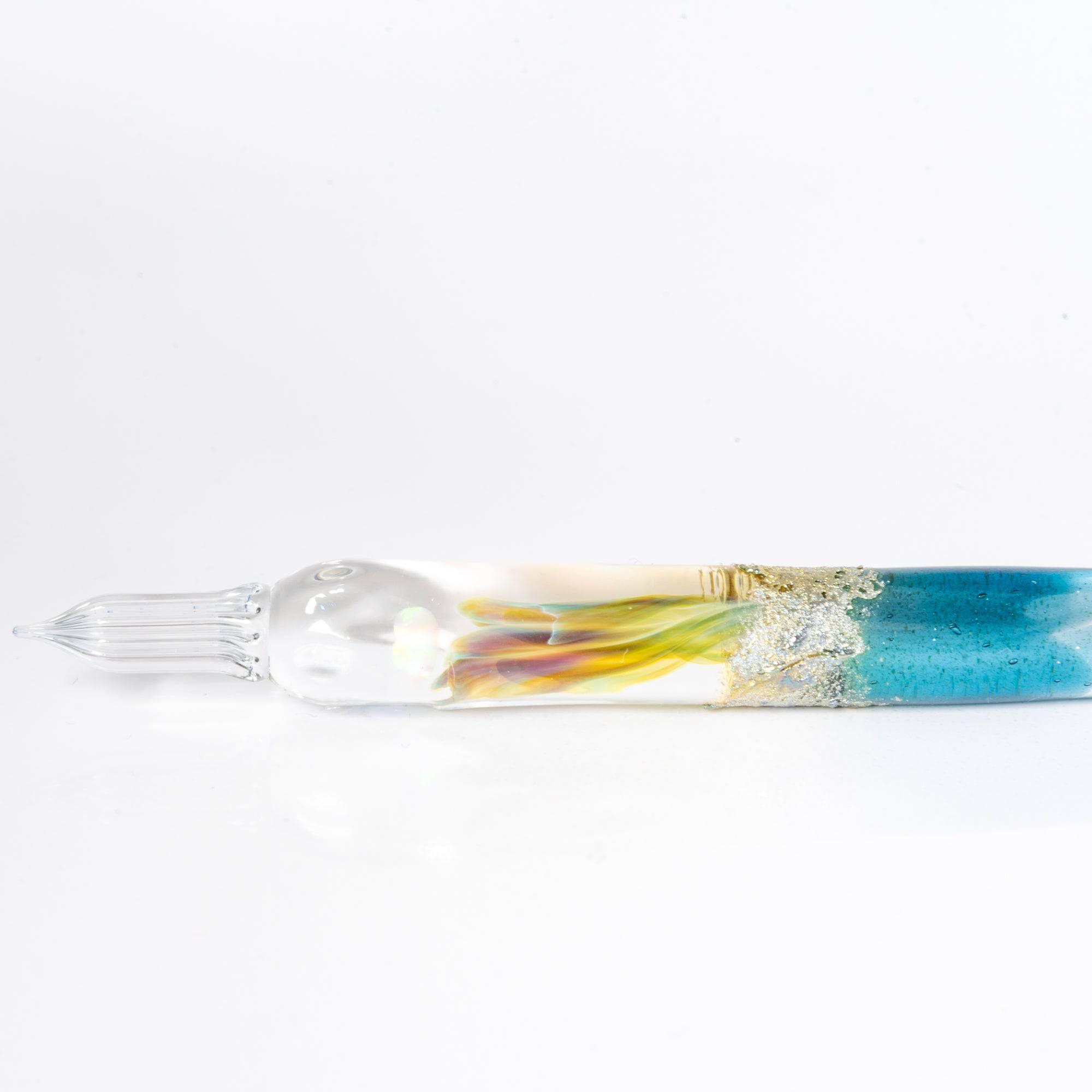 Glass pen with a light blue gradient and suspended opal, accented with silver. A luxurious writing instrument for those who appreciate elegance.