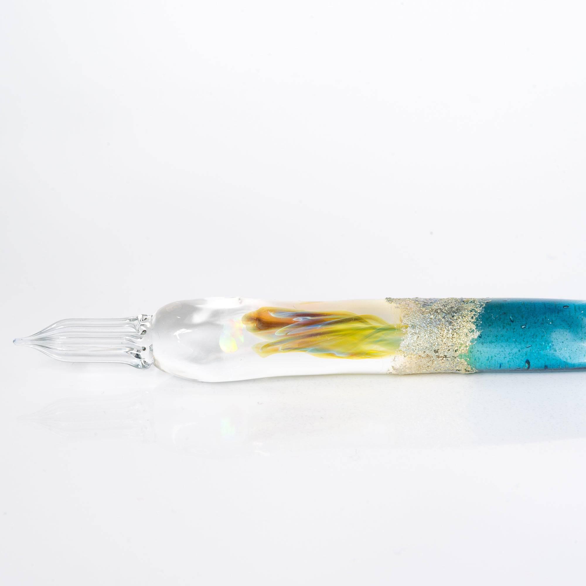 Glass pen with a light blue gradient and suspended opal, accented with silver. A luxurious writing instrument for those who appreciate elegance.