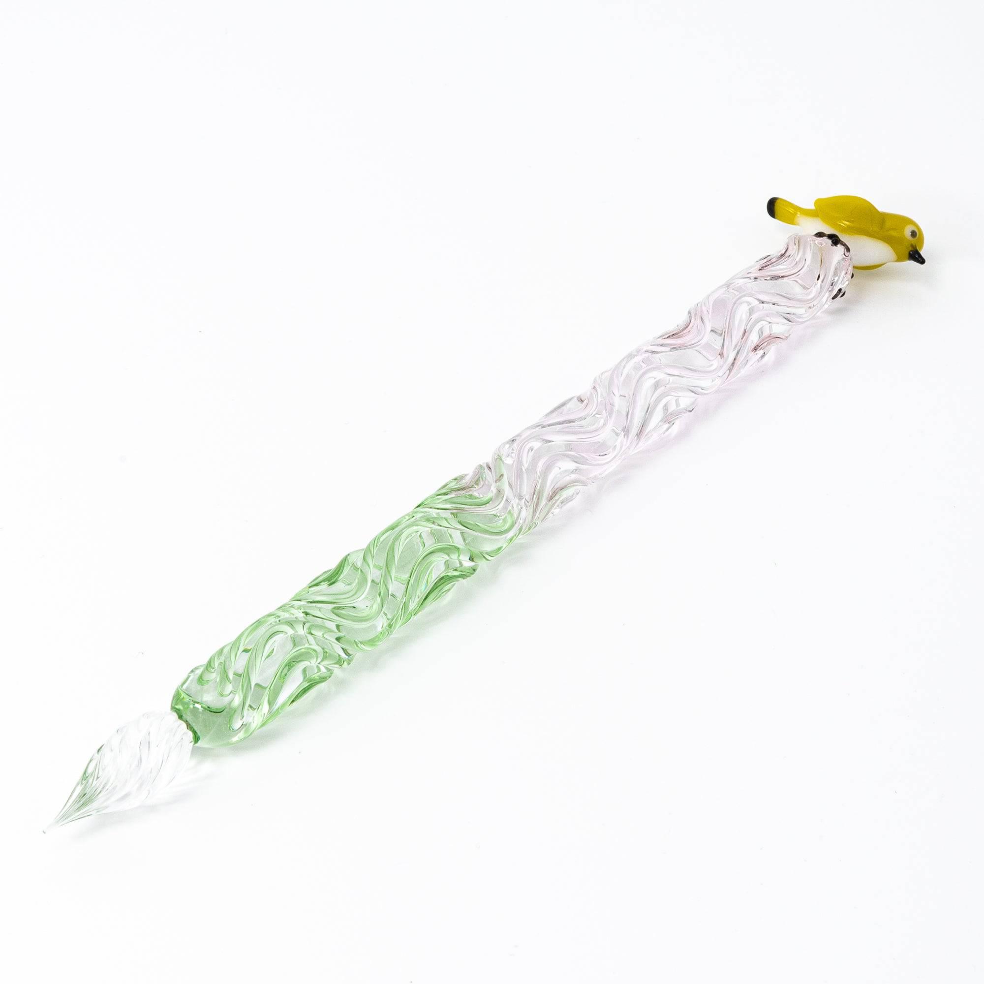 Glass pen with a bird topper and a two-tone twisted shaft in green and pink. The intricate design adds elegance to your writing experience.